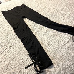 Black leggings with lace up at the bottom.